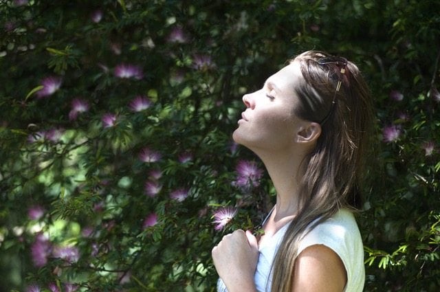 Woman meditating in garden
